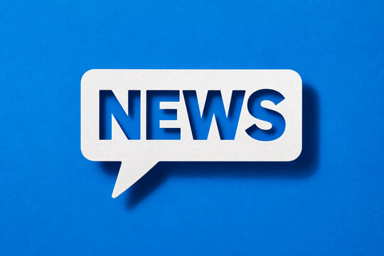 White speech bubble containing cut out bold letters spelling news floating against a vibrant blue textured background providing a modern minimalist visual concept for digital media and current daily r