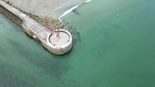 High Angle Footage of Beach and Ocean at Looe Town of England During Hot Sunny Day. Looe is a coastal town and civil parish in southeast Cornwall, England, United Kingdom.