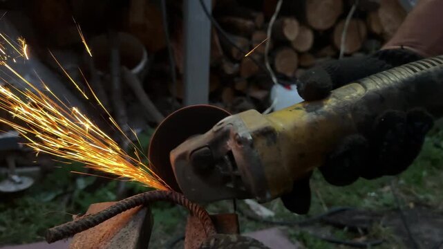 Man Cutting Metal with Angle Grinder, Sparks Flying in Workshop. Metalworking process in a workshop, suitable for construction, fabrication, welding, repair, engineering, and DIY projects.
