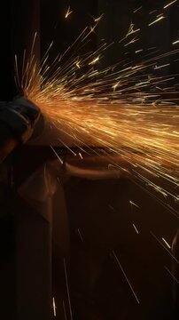 Man Cutting Metal with Angle Grinder, Sparks Flying in Workshop. Metalworking process in a workshop, suitable for construction, fabrication, welding, repair, engineering, and DIY projects.