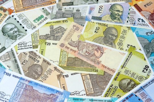 Indian rupee money bills in pile on table. India INR currency cash close up