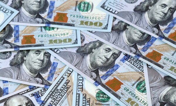 US dollar money hundreds in pile on table. United States USD currency cash close up