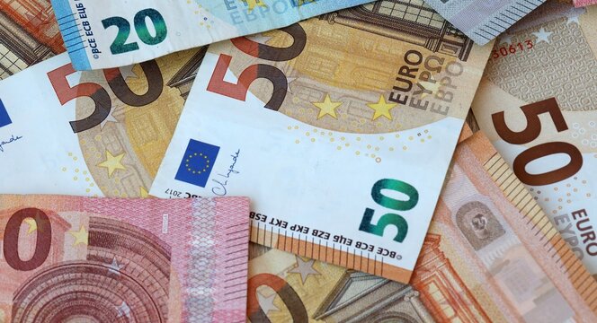 Euro money bills in pile on table. Eurozone EUR currency cash close up