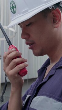 Environmental engineer conversation with team of technicians use radio, tablet and taking report to continuous emission monitoring systems at industrial plant. Sustainable air pollution reduction. ESG