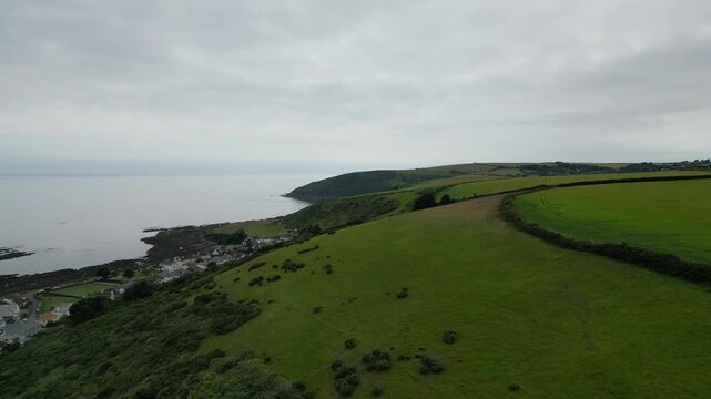 High Angle Footage of Beach and Ocean at Looe Town of England During Hot Sunny Day. Looe is a coastal town and civil parish in southeast Cornwall, England, United Kingdom.