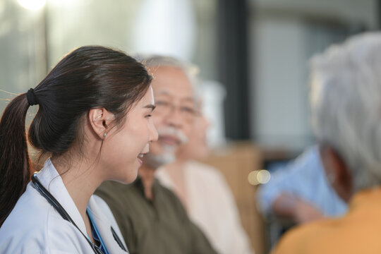 Nursing care: Elderly patient in a wheelchair pushed through a sunny hospital garden by a caregiver, surrounded by greenery during outdoor rehabilitation, captured with frame 6346