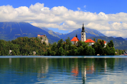 Lake Bled, Slovenia: Scenic view of the Assumption of Mary Church on the island with Bled Castle on a cliff and mountains