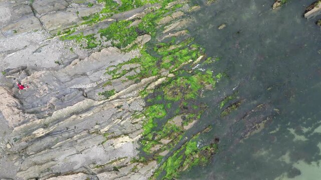 High Angle Footage of Beach and Ocean at Looe Town of England During Hot Sunny Day. Looe is a coastal town and civil parish in southeast Cornwall, England, United Kingdom.