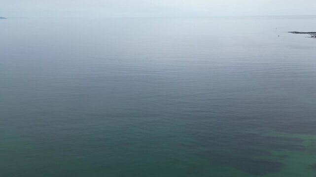 High Angle Footage of Beach and Ocean at Looe Town of England During Hot Sunny Day. Looe is a coastal town and civil parish in southeast Cornwall, England, United Kingdom.