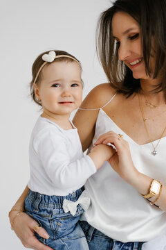 Young Mother Holding Hands With Small Daughter