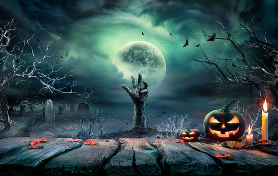 Halloween Zombie - Hands Rising Out Of A Cemetery At Moonlight With Full Moon