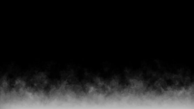 Gradual transition of smoke rising from the ground, creating mysterious atmosphere. Continuous flow of white smoke creating captivating visual effect against dark background