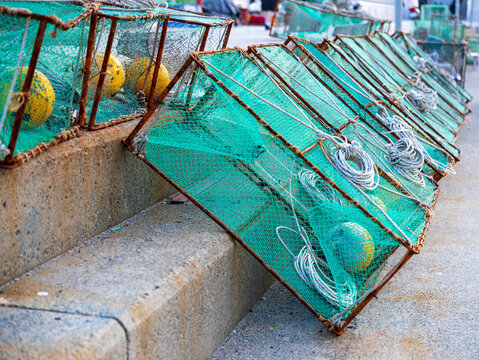 View of green fishing nets and yellow buoys arranged on concrete steps in Busan, Busan, South Korea.