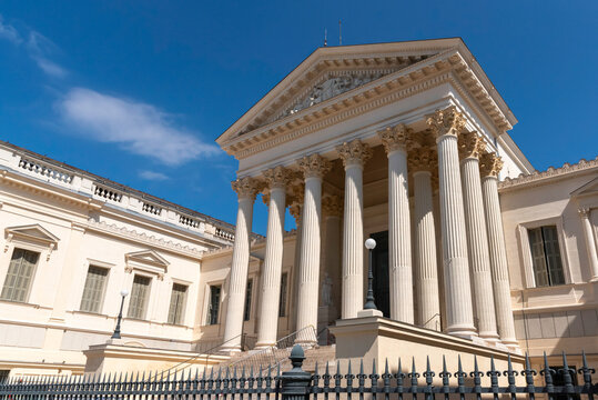 Grand columned courthouse facade beneath a blue sky in Montpellier
