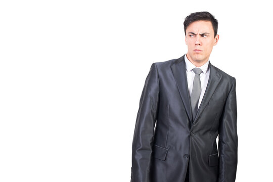 Distrustful male manager in formal suit looking away with puzzled look