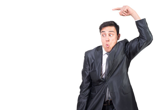 Mid shot of astonished male in elegant suit pointing aside while promoting ad