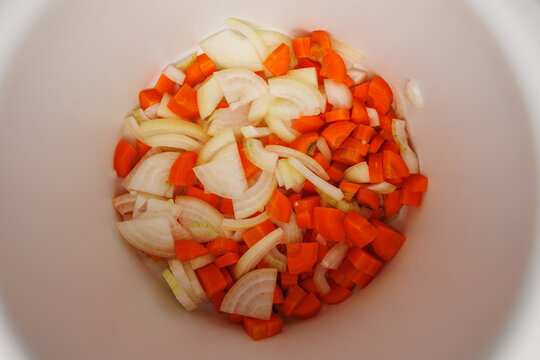 Chopped onion and carrot prepared for home cooking