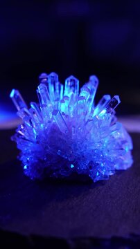 A mysterious, magical, genuine crystal. The grown crystal rotates on a turntable illuminated by full-spectrum RGB lighting. A scientific experiment and chemical study. A beautiful background