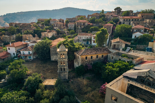 Drone view of small Albanian village built on rocky hillside, real Mediterranean landscape and rural lifestyle illustration in QEPARO FUSHE, ALBANIA