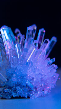 A mysterious, genuine crystal. The grown crystal rotates on an illuminated turntable. A scientific experiment and chemical study. A beautiful background or screensaver. Blue.