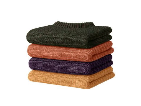 Stack of colorful folded knit sweaters in warm autumn tones, featuring green, orange, purple, and yellow woolen garments on a black bac