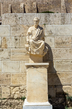 Marble sculpture of the ancient Greek dramatist Menander seated among ruins at the Acropolis, capturing classical art, archaeology and cultural heritage in sunlight and shadow