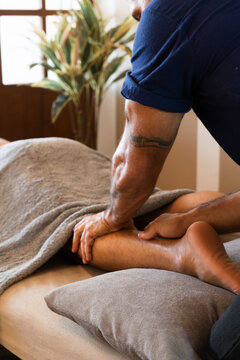 Professional Therapist Giving Relaxing Leg Massage at Wellness Spa