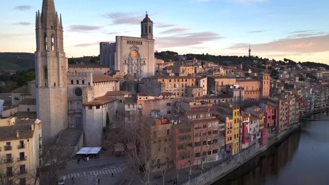 Girona at Sunset time, Aerial Shot. Fly over the Historical Center with Colorful Houses and Cathedral of Girona, Spain.