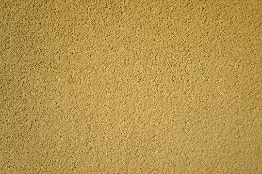Gelbe raue Betonwand als Hintergrund