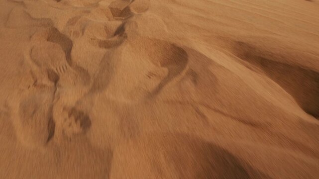 First-person view of fast forward movement along tracks on sand dunes, Close-up