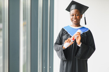 African american female graduate holding university diploma