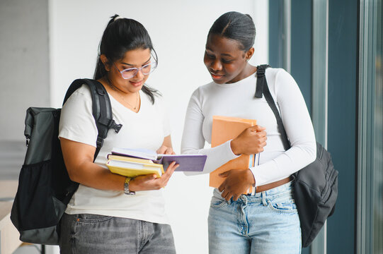 Diverse female students studying together at university