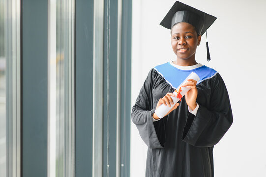 African american female graduate holding university diploma
