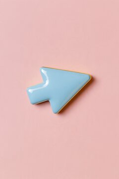 Glossy blue arrow symbol on a soft pink background, minimalist concept for direction, navigation and growth