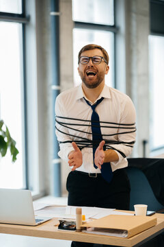 Businessman feeling trapped by work stress and deadline