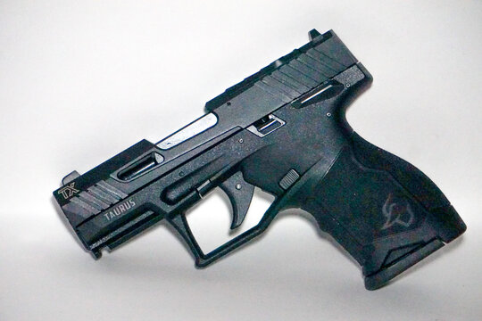 A Taurus TX 22 LR handgun with white background. A Brazilian made self-defense, target practice firearm pistol.