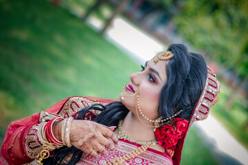 Side Profile Portrait of Beautiful South Asian Bride Looking Up Outdoors © Rejaul Karim