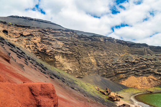 Volcanic rock formation and layered crater wall at Charco Verde near El Golfo village, Lanzarote, Canary Islands, Spain
