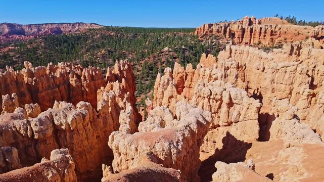 Golden sunrise light glows across the panoramic hoodoo formations along the Fairyland Trail in Bryce Canyon National Park