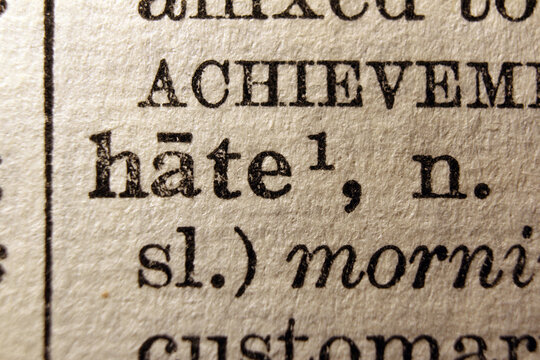 Word hate printed on dictionary page, macro close up

