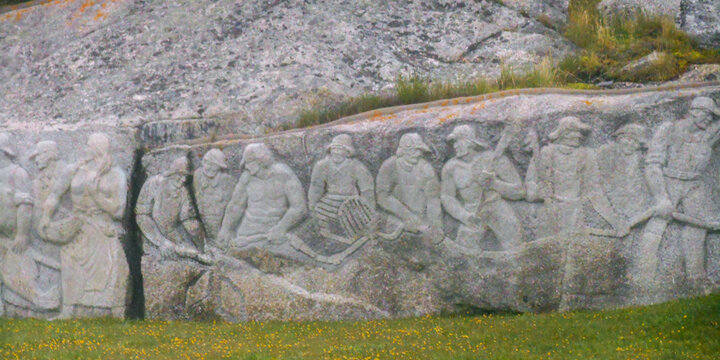 PEGGY&rsquo;S COVE, NS &mdash; JUNE 18, 2018: Figures representing Nova Scotian fishermen and their families appear in the William E. deGarthe Memorial Monument carved into a granite outcropping.
