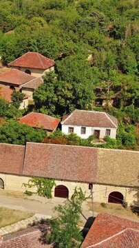 Aerial around view of old rustic vintage houses with wine cellars in Rogljevacke pivnice in Negotin region of Serbia. Vertical video 4k