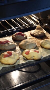Homemade cookies go wrong in the oven, spreading too much and getting slightly burnt. A relatable baking fail in a cozy kitchen vertical video