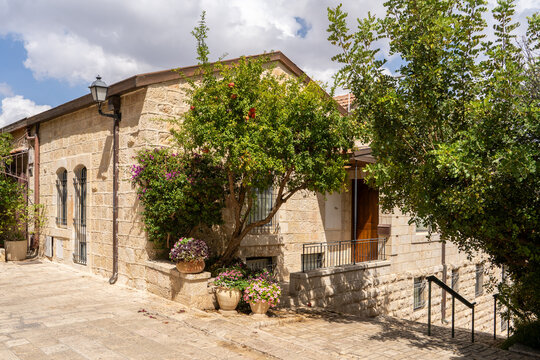 Charming streets and traditional Jerusalem stone houses surrounded by beautiful greenery in historic Yemin Moshe, Jerusalem, Israel