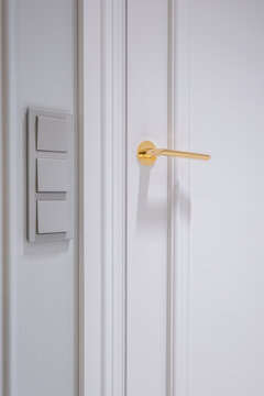 door handle on white wooden door in interior. Knob close-up elements. Door handle, fittings for interior design