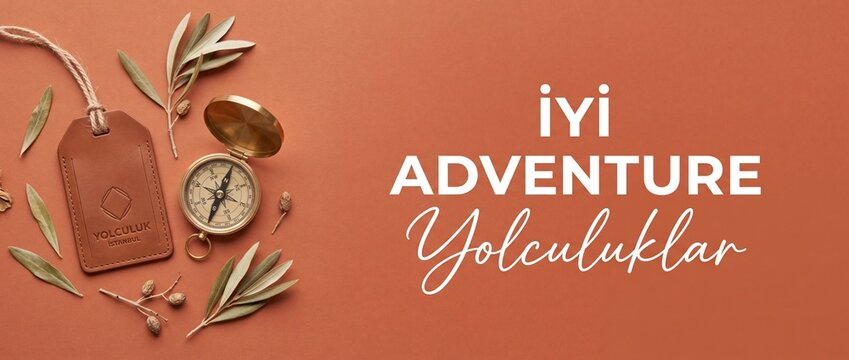 Travel adventure compass leather tag on terracotta background with olive leaves and Turkish text iyi yolculuklar for happy journey bon voyage holiday exploration navigation banner with copy space.