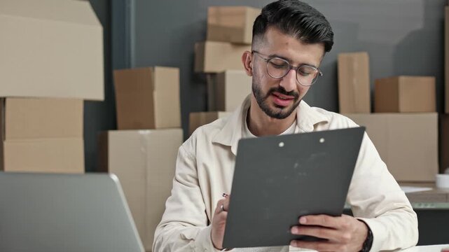 Young man reviews files with focus and calm