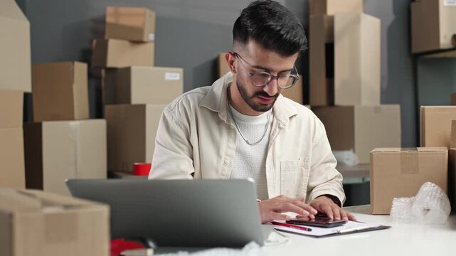Young man works with laptop and documents
