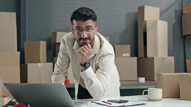 Man sits at desk, thinking deeply