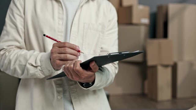 Person holds clipboard, pencil ready to jot down notes